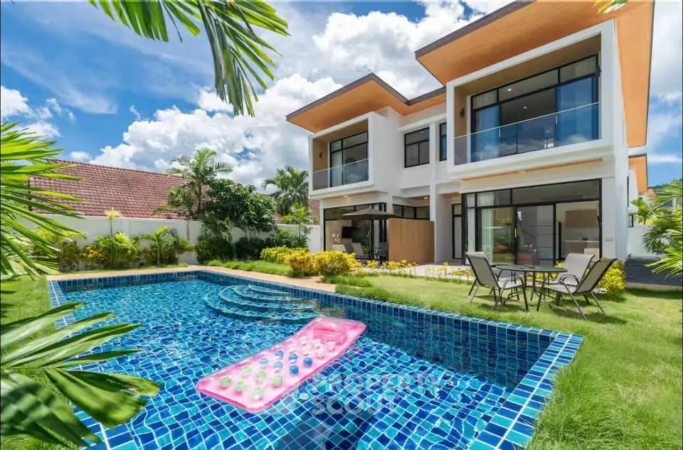 Luxurious modern villa with private pool and lush garden, perfect for relaxation and entertaining.