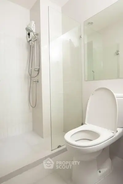 Modern bathroom with glass shower and white fixtures