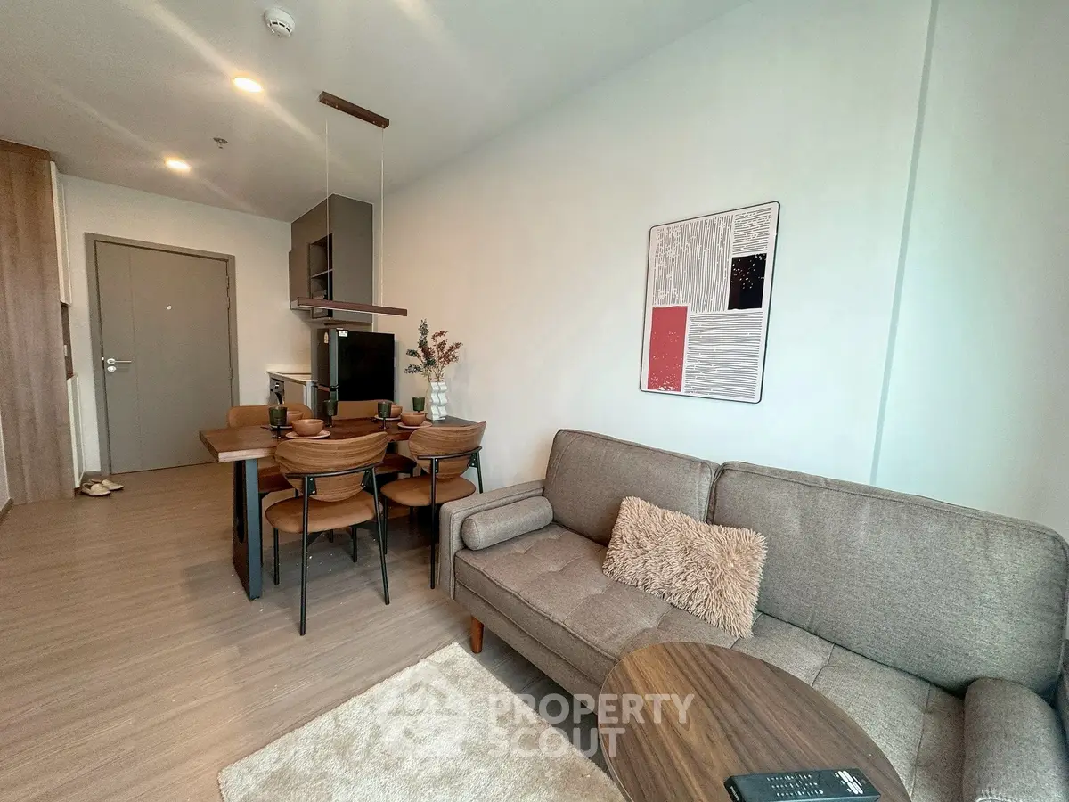 Modern living room with cozy sofa and dining area in stylish apartment