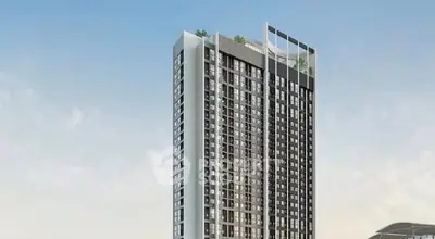 Modern high-rise building with sleek design and rooftop greenery.