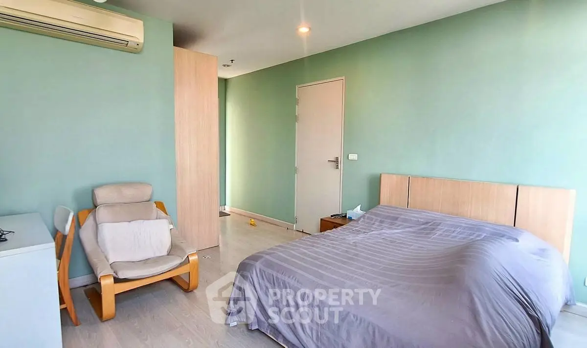 Spacious bedroom with modern decor and air conditioning in a stylish apartment.