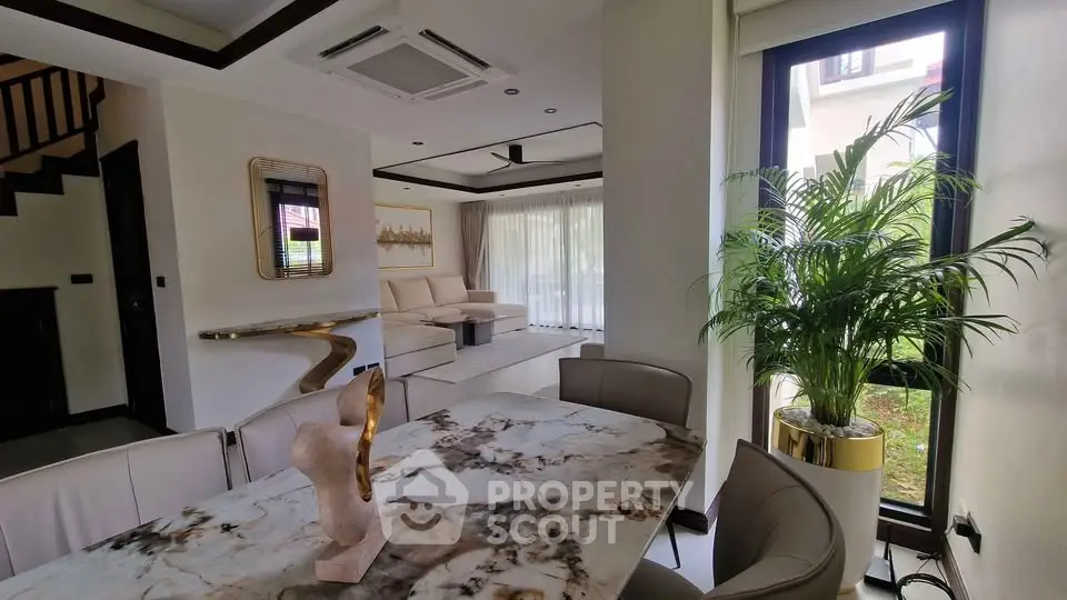 Luxurious modern living room with elegant dining area and large windows for natural light.