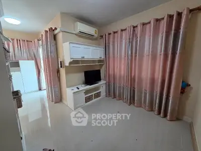 Spacious living room with modern decor and ample natural light