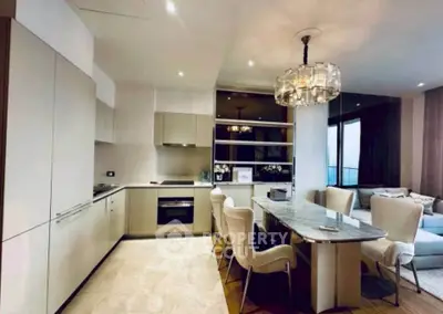 Luxurious open-plan kitchen and dining area with modern appliances and elegant decor.