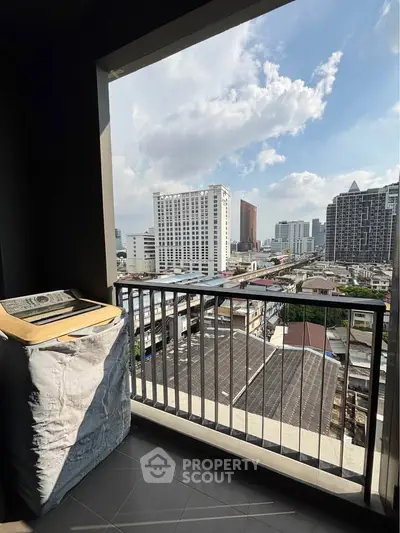 High-rise balcony with cityscape view and washing machine, perfect for urban living.