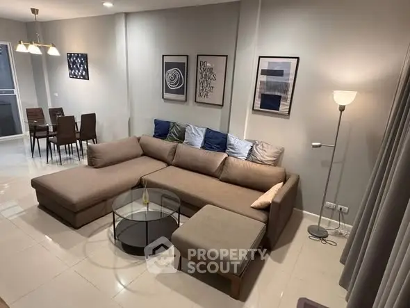 Spacious modern living room with stylish decor and comfortable seating in a contemporary apartment.