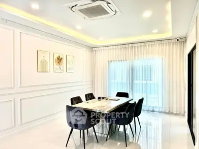 Elegant dining room with modern decor and large windows