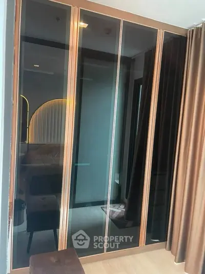 Modern bedroom with sleek mirrored wardrobe and stylish lighting
