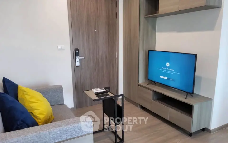 Modern living room with sleek furniture and TV, perfect for cozy relaxation.