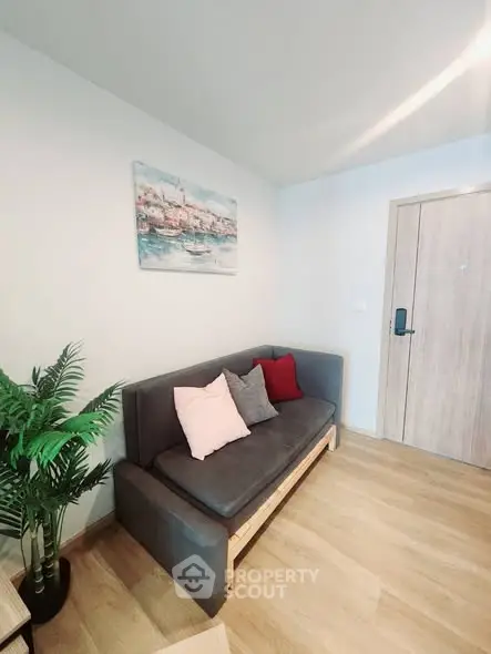 Cozy living room with modern sofa and stylish decor in a bright apartment.