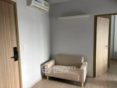 Modern minimalist living room with beige sofa and air conditioning