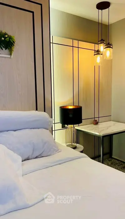 Elegant bedroom with modern lighting and stylish decor, perfect for a cozy retreat.