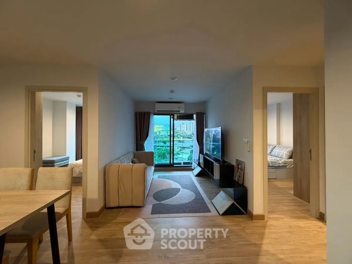 Spacious modern living room with balcony view in stylish apartment