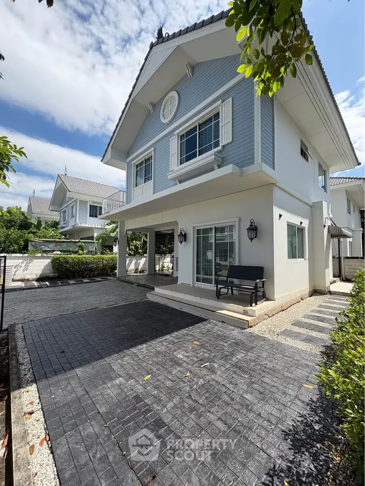 Charming two-story house with modern design and spacious driveway in a serene neighborhood.