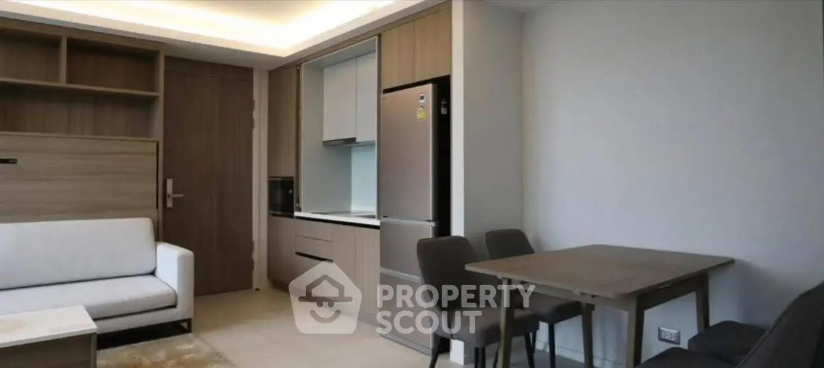 Modern apartment interior with sleek kitchen and cozy living area, perfect for urban living.
