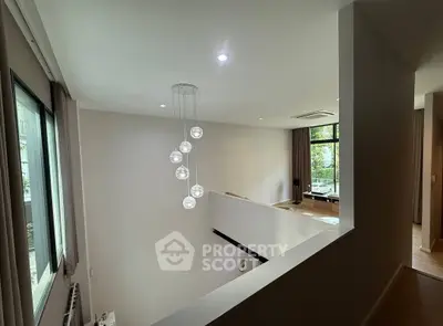 Modern living room with high ceiling and stylish lighting in a contemporary home.