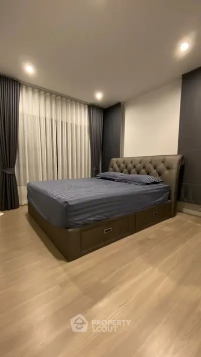 Spacious bedroom with elegant bed and modern decor, perfect for relaxation and comfort.