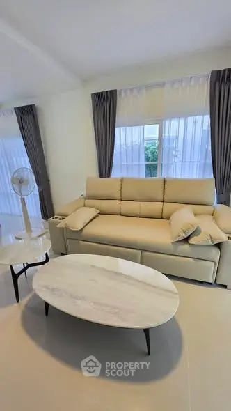Modern living room with beige sofa and elegant coffee table, perfect for relaxation and entertaining.
