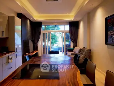 Luxurious modern living room with elegant wooden table and cozy seating area.