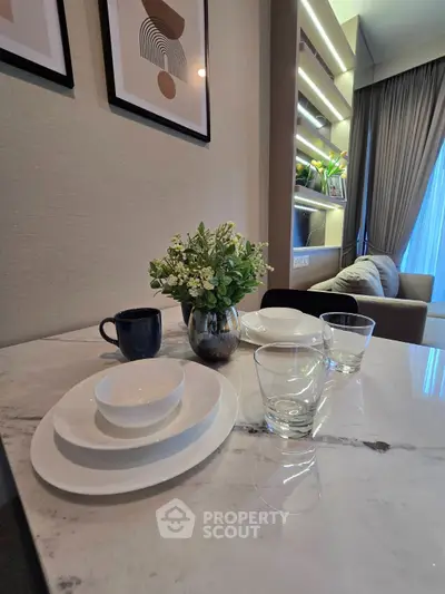 Modern dining area with elegant table setting and cozy living room view