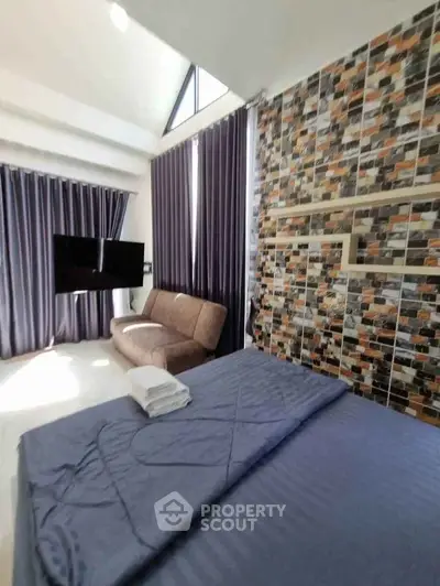 Modern bedroom with stylish decor and large windows for natural light