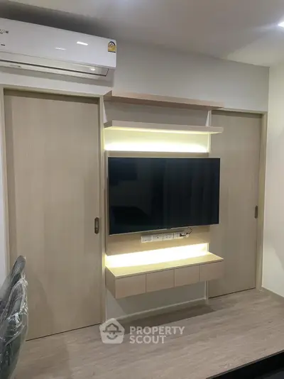 Modern living room with sleek TV unit and ambient lighting