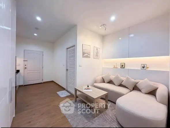 Modern living room with cozy sofa and stylish decor in a contemporary apartment.