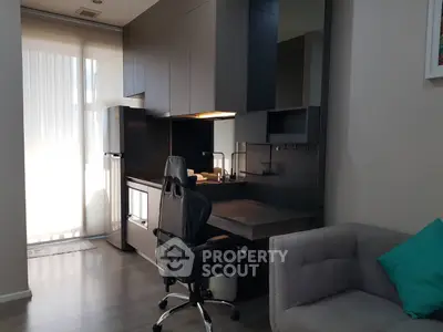 Modern study area with sleek black cabinetry and ergonomic chair in a stylish apartment.