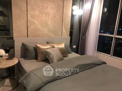 Luxurious bedroom with elegant decor and city view, featuring plush bedding and ambient lighting.