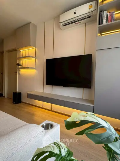 Modern living room with sleek TV setup and ambient lighting