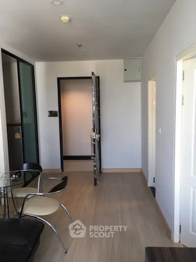 Modern apartment interior with open door and stylish furniture