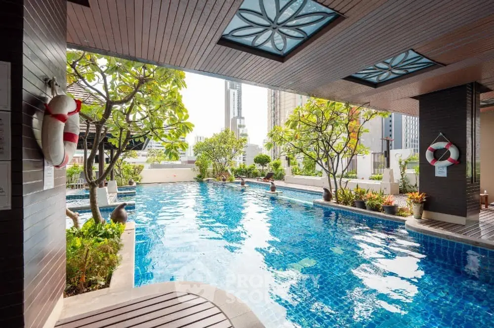 Luxurious rooftop pool with city skyline view and lush greenery