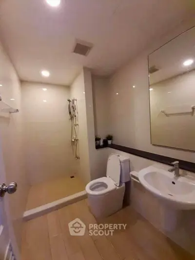 Modern bathroom with shower, toilet, and sink in a sleek design