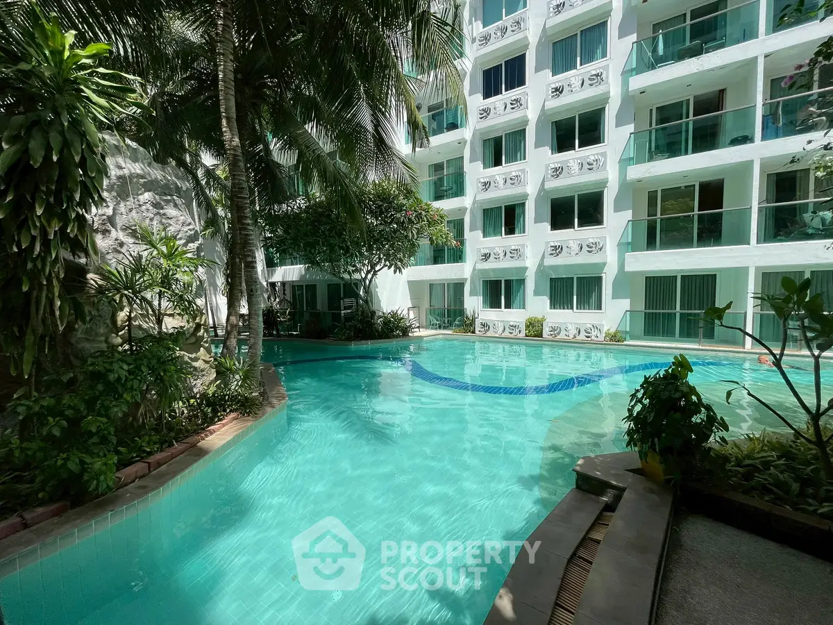 Luxurious apartment complex with stunning pool and lush greenery, perfect for relaxation and leisure.