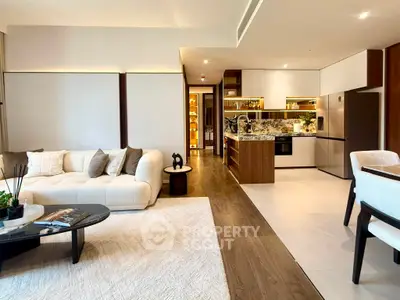 Luxurious open-plan living room and kitchen with modern decor and elegant furnishings.