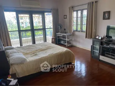 Spacious bedroom with balcony access and natural light