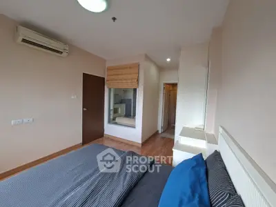 Spacious bedroom with modern decor and air conditioning in a stylish apartment.