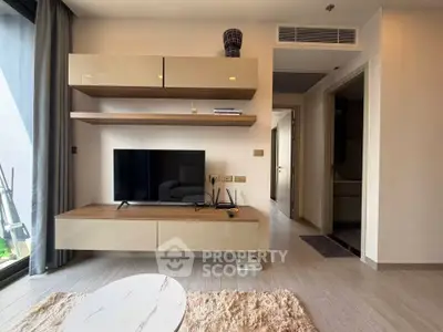 Modern living room with sleek TV unit and stylish decor in a contemporary apartment.
