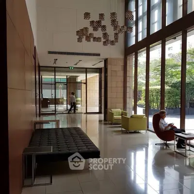 Luxurious modern lobby with high ceilings and stylish seating in a prestigious building.