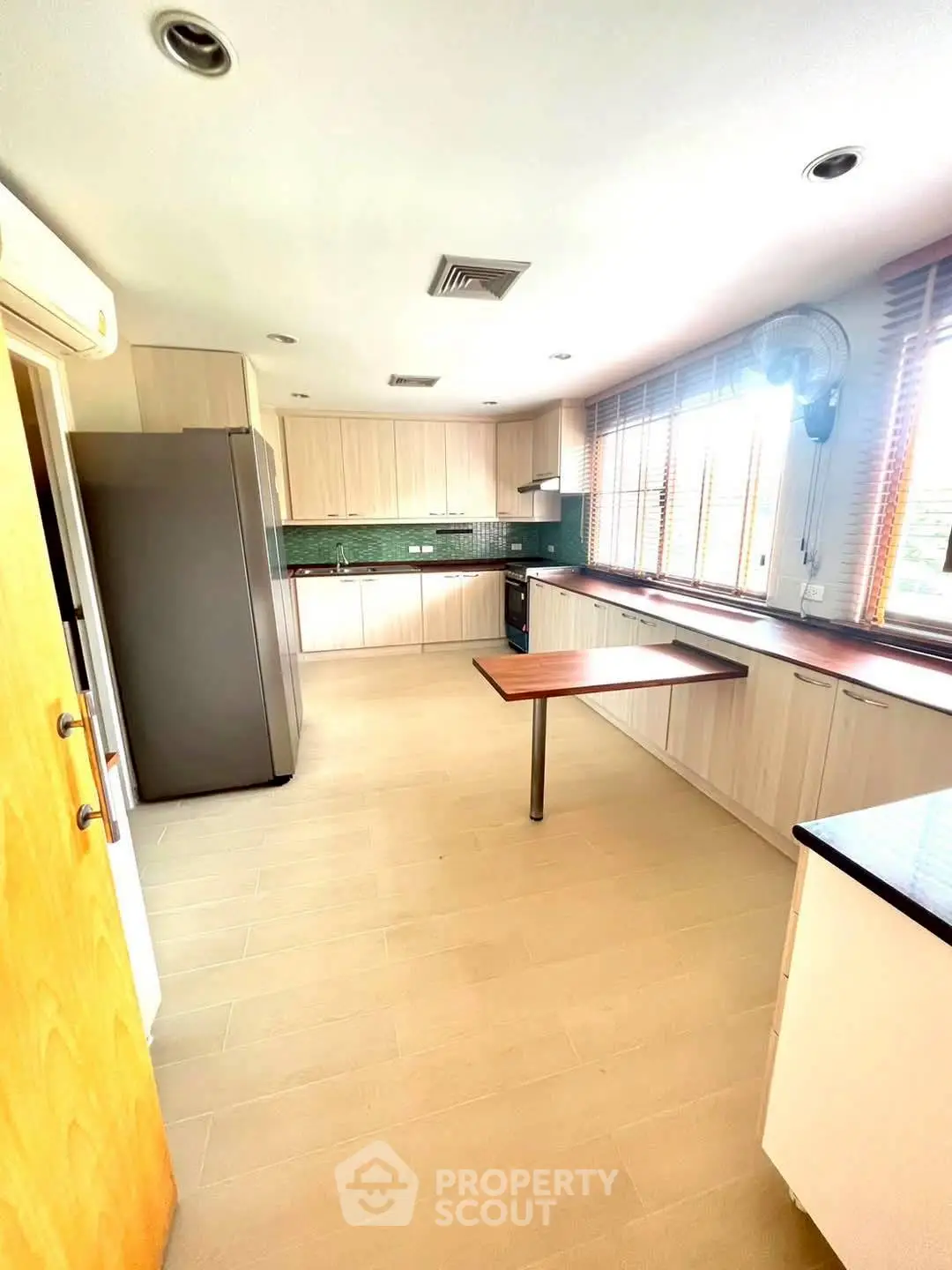 Spacious kitchen with modern appliances and large windows for natural light.
