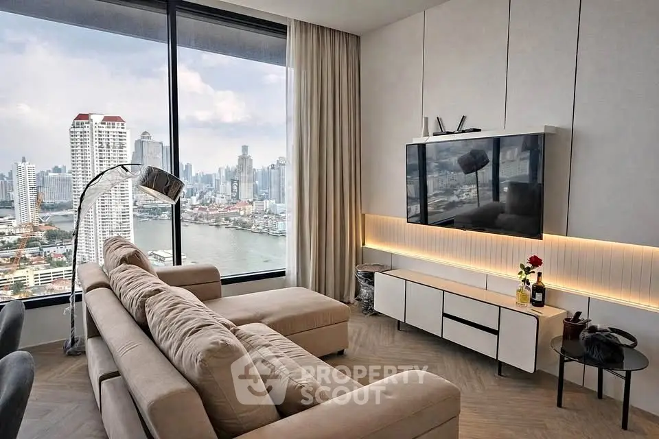 Luxurious living room with stunning city and river view, modern decor, and elegant furnishings.
