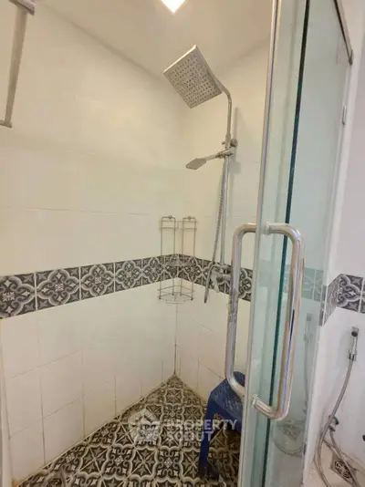 Modern bathroom with stylish shower and patterned tiles