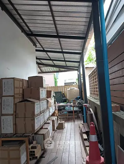 Spacious outdoor storage area with wooden flooring and ample shelving space.