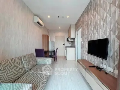 Modern living room with stylish decor and open kitchen layout in a contemporary apartment.