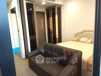 Cozy bedroom with elegant bed and stylish sofa, perfect for relaxation.