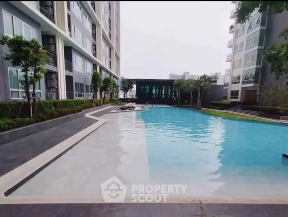 Luxurious apartment complex with stunning outdoor pool and modern architecture.