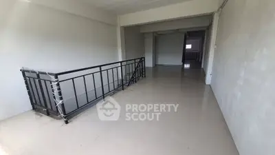 Spacious interior with sleek railing and polished floors, ideal for versatile use.