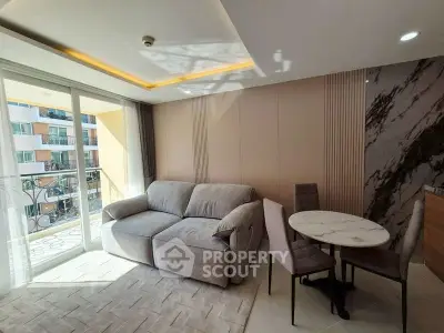 Modern living room with cozy sofa and dining area, featuring elegant decor and natural light from balcony.