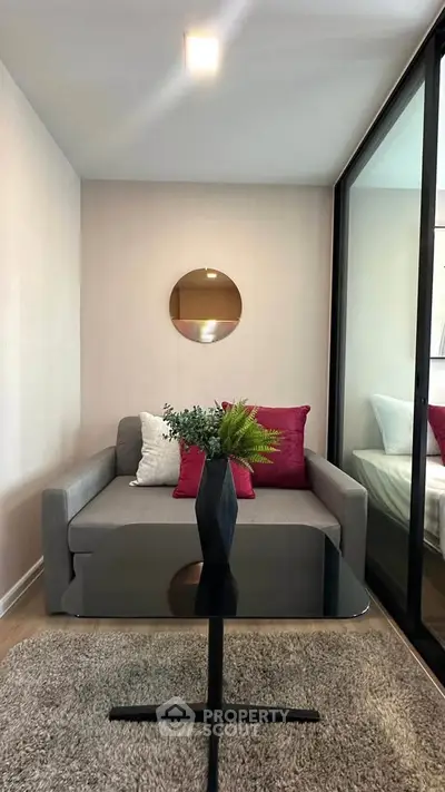 Cozy living room with modern decor and glass partition, perfect for urban living.