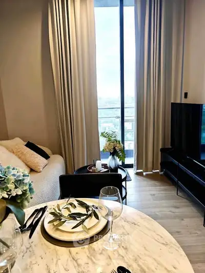 Chic modern living room with balcony view, elegant decor, and stylish dining setup.